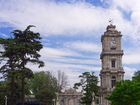 Dolmabahce Palace entrance with clock tower under blue sky with clouds. Istanbulの写真素材