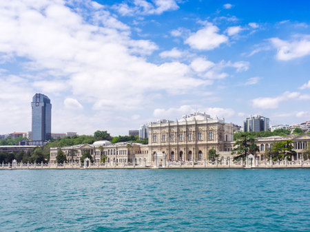 Scenic view of Dolmabahce Palace along the Bosphorus strait in Istanbul, Turkey, with modern buildings behindの写真素材
