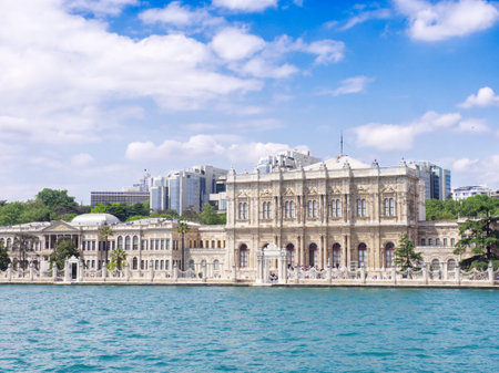 Iconic Dolmabahce Palace in Istanbul viewed from the Bosphorus with turquoise waters and blue skyの写真素材