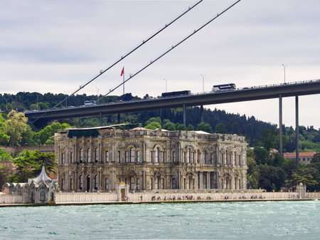 Historic Beylerbeyi Palace on the Bosphorus shore with modern bridge overhead in Istanbul, Turkeyの写真素材