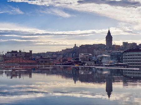 Scenic view of Istanbul cityscape with Galata Tower, reflected in tranquil Bosphorus waters at duskの写真素材