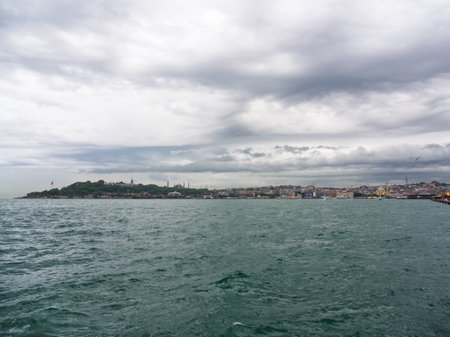 View of Istanbuls historic peninsula and skyline from the Bosphorus Strait under cloudy skiesの写真素材