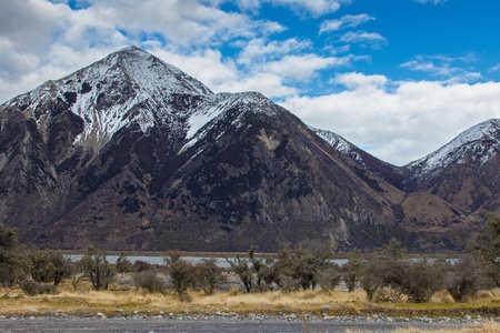 Looking out over a river and snow capped mountains in mid Canterbury New Zealandの写真素材
