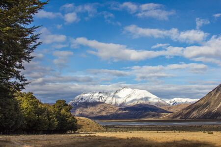 Looking out over a river and snow capped mountains in mid Canterbury New Zealandの写真素材
