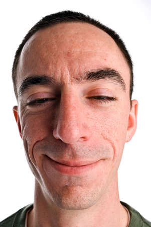 A headshot of a caucasian male with a smile and an odd look on his face, almost as if he has been drinking の写真素材