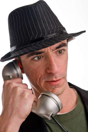 Headshot of Caucasian male wearing a fedora style hat talking on the phoneの写真素材