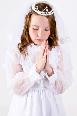 Young girl in First Communion dress prayingの写真素材