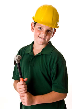 A young boy wearing a hard hat and holding a hammer while in thought isolated on a white background.の写真素材