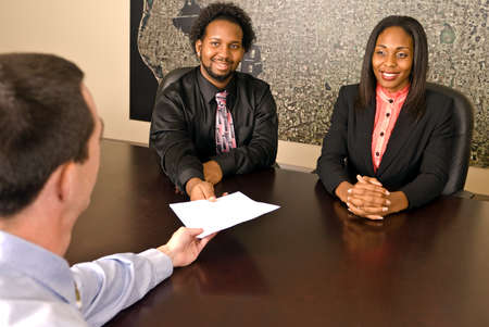 Young African American couple about to sign papersの写真素材