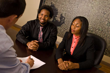 Young African American couple about to sign papersの写真素材