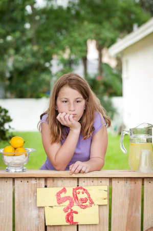 Bored young girl with no customers at her lemonade standの写真素材