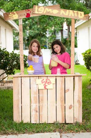 Two young girls selling lemonadeの写真素材