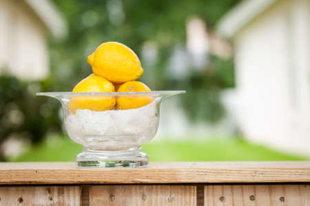 Lemons in a glass bowl at an outdoor lemonade standの写真素材