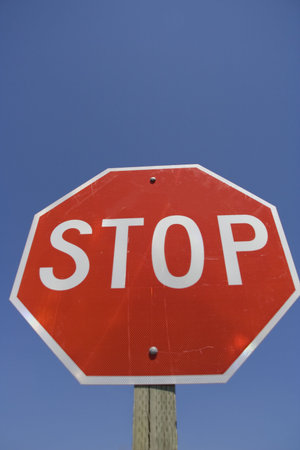 Stop Sign with isolated blue background