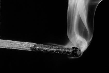 Match and smoke on a black backgroundの写真素材