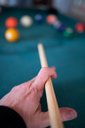 Close-up of a man's hand playing billiardsの写真素材