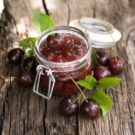 Fresh cherry jam in a preserving glassの写真素材