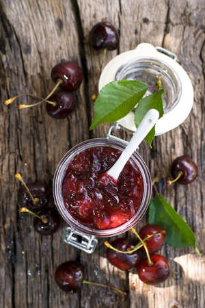Fresh cherry jam in a preserving glassの写真素材