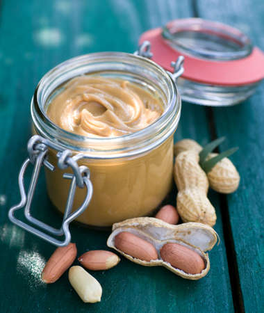 Fresh peanut butter on wooden ground の写真素材