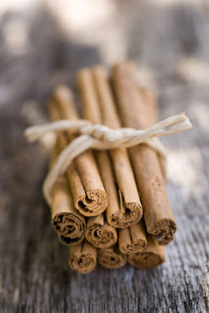 Cinnamon sticks on wooden groundの写真素材