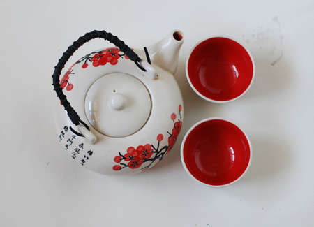 Chinese teapot with two cups on whiteの写真素材