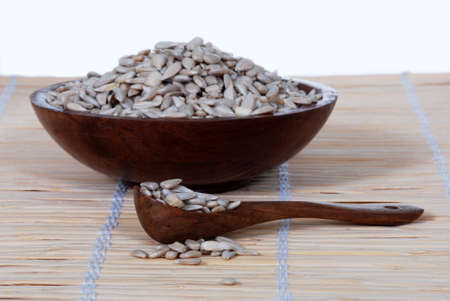 Sunflower seeds in a wood spoon, bowl の写真素材