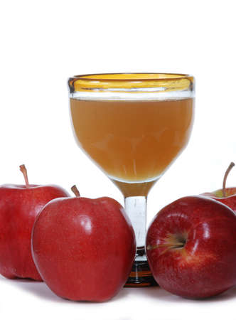 Red apples with a glass of unfiltered organic apple juiceの写真素材