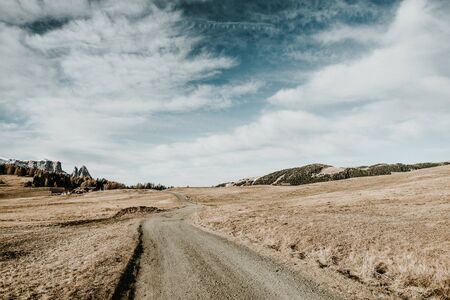 A path leading through a field in the mountains in northern italy.の写真素材