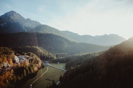 A mountain rage with a valley at sunset. The sun is creating a nice flare in the picture.の写真素材
