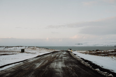 A road leading through a snowy landscape in Iceland