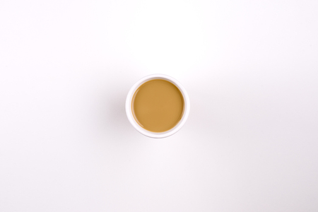 Coffee with milk in a mug on white backgroundの写真素材