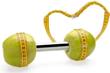 Apple dumbbell, carrying out a healthy lifestyle, a diet and exercises with loveの写真素材