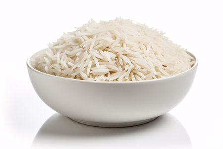 A bowl of fragrant Basmati rice isolated on white, representing a fresh Asian cuisine.の素材