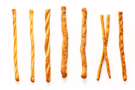 A crispy, dry homemade pretzel, glistening in salt, sits atop a white backdrop.の素材
