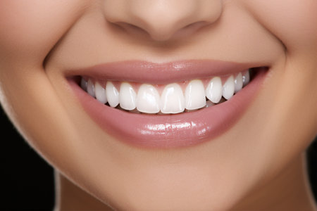 Close-up of a woman with radiant ivory incisors beaming.の素材