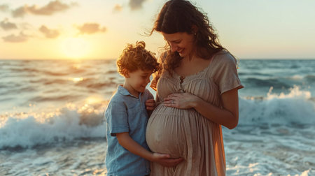 Pregnant woman's belly being touched by her son at the beach.の素材