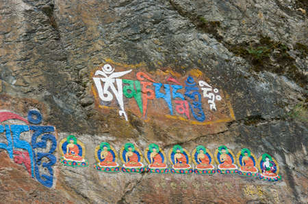 The Sanskrit mantra 'Om mani padme hum' inscribed and painted on a stone of the Potala Palace in Lhasa, Tibet, China.のeditorial素材