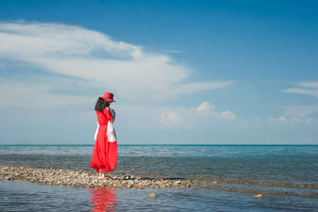a view of chinese girl's back, side of Qinghai lake, china.のeditorial素材