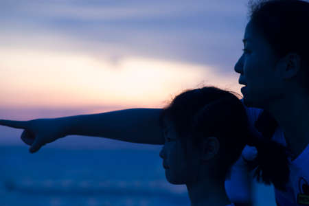Woman and child staring out into the horizonのeditorial素材
