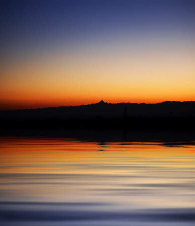 A colored sunset reflect on the seaの写真素材