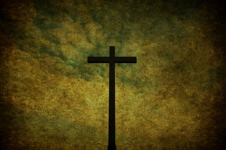 A cracked yellow grunge wall with metal crossの写真素材