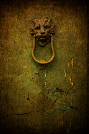 A cracked yellow grunge door with metal handleの写真素材