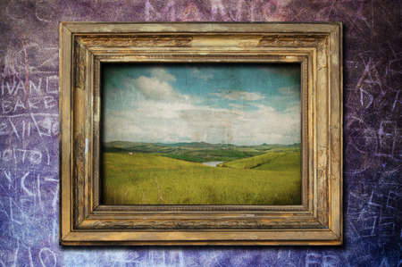 A vintage golden frame on a dark purple wallの写真素材