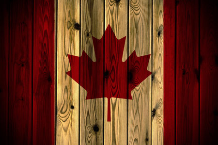 A Canada flag painted on a wooden wallの写真素材
