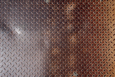 Background of old metal diamond plate in brown color