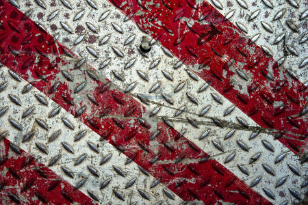 Background of old metal diamond plate in red and white colorsの写真素材