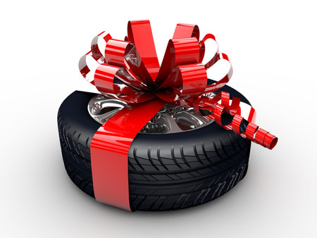 A tyre with a red ribbon like a presentの写真素材