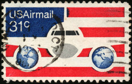 UNITED STATES - CIRCA 1976  stamp printed in United states, shows Plane Globes and flag, circa 1976の写真素材