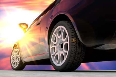 A black car seen by back in front of a sunset