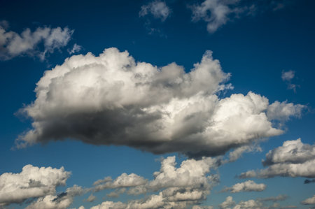 Many white sparse clouds over blue sky